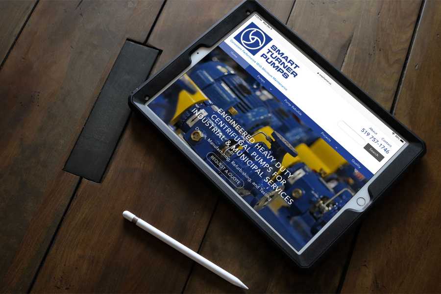 iPad on wooden table displaying Smart Turner Pumps landing page.